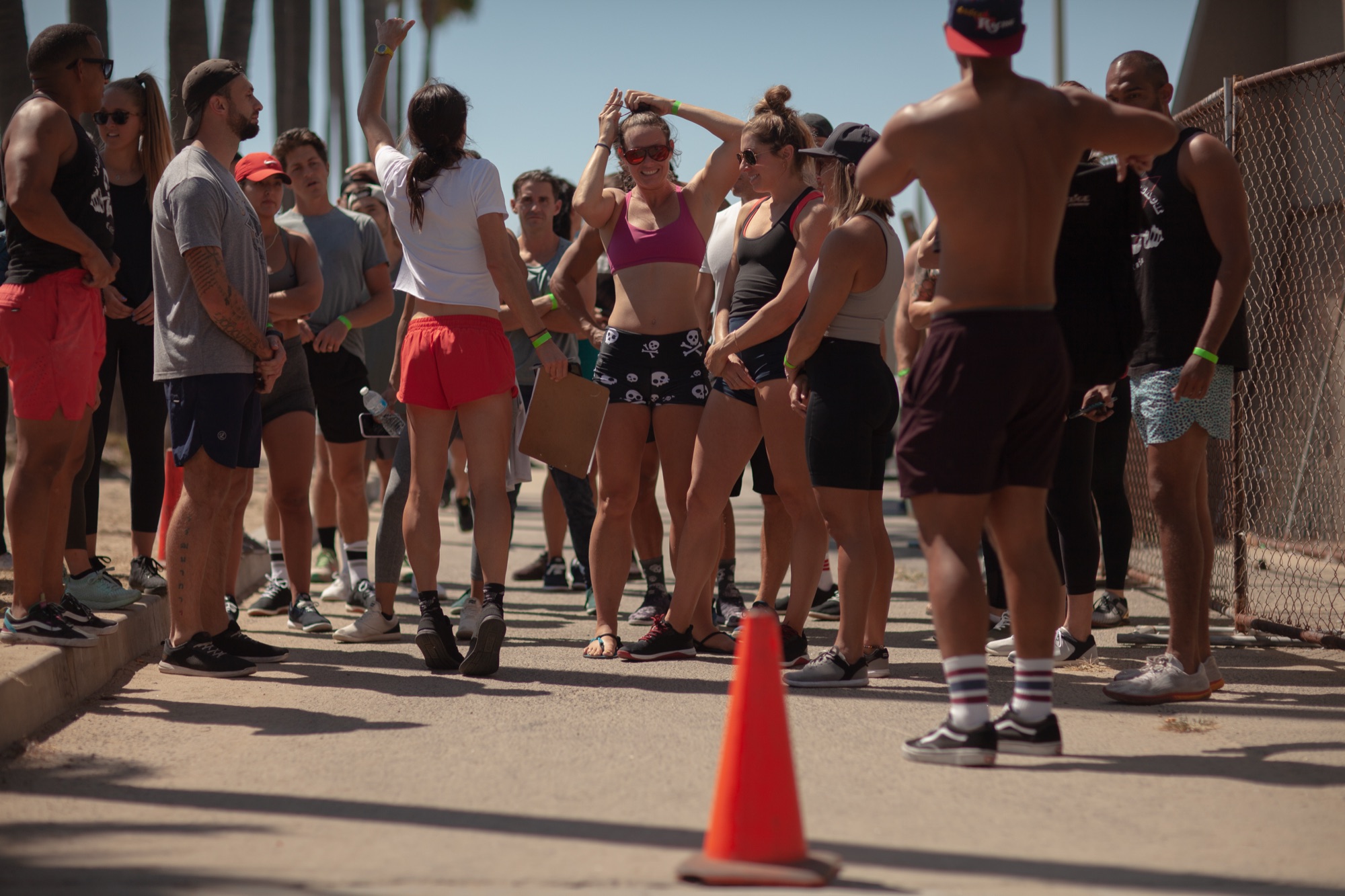 A loose huddle of runners stretching at the Venice Pier turnaround.
